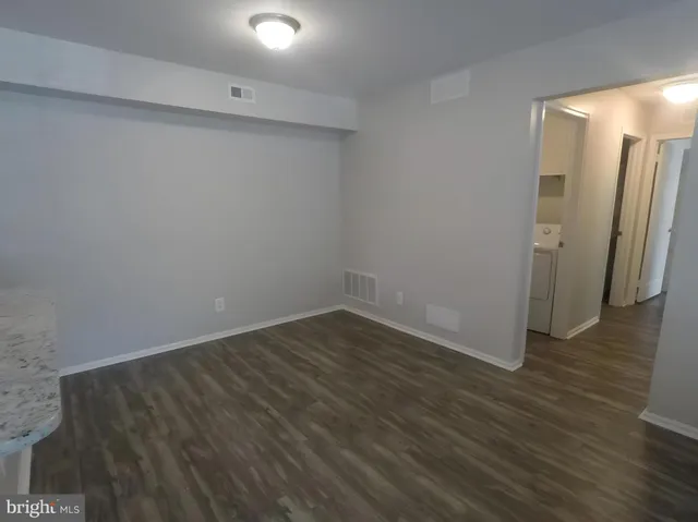 a view of a room with wooden floor