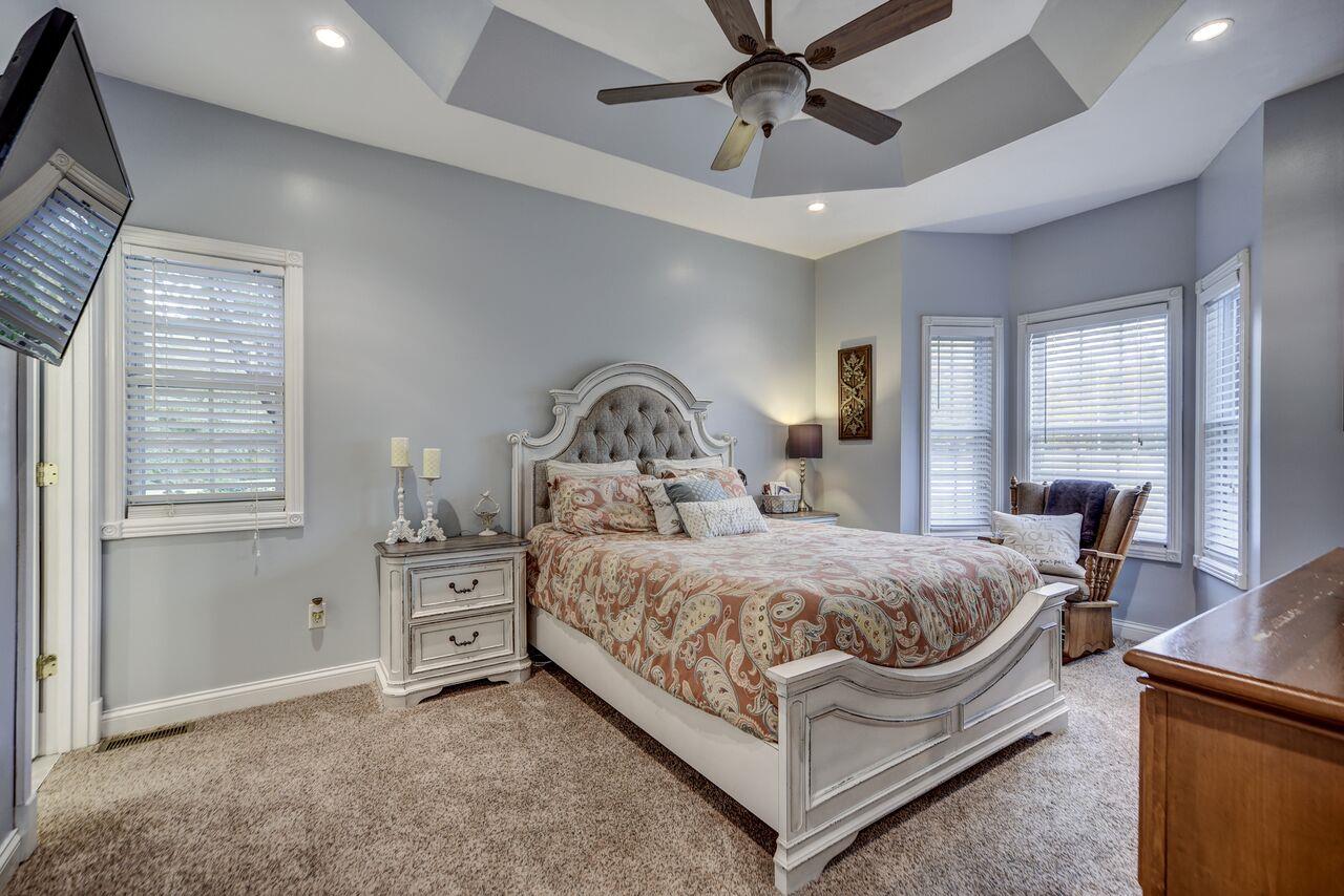 1105 North Corinth Road Portland, TN 37148 - Photo 6 of 16 a bedroom with a bed and a chandelier
