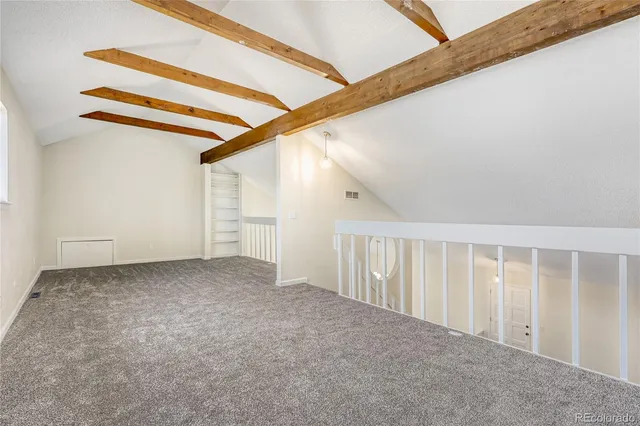 a view of an empty room with stairs