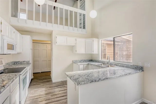 a kitchen with granite countertop a sink and a stove