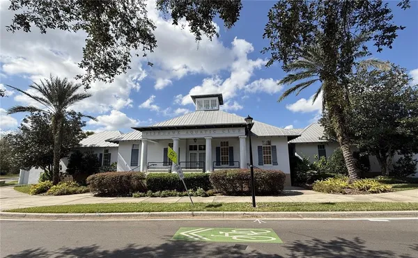 a view of a house with a garden and trees