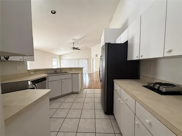 a kitchen with a sink a stove and refrigerator