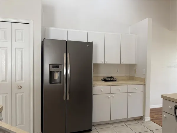 a kitchen with cabinets stainless steel appliances and a counter space