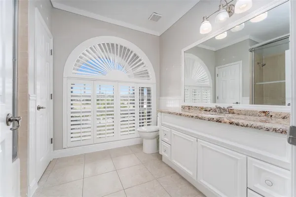 a bathroom with a granite countertop sink a mirror and a bathtub