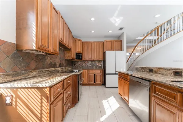 a stove top oven sitting inside of a kitchen
