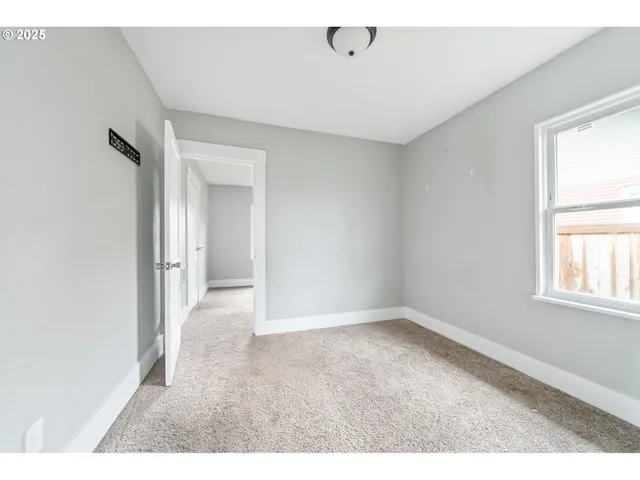 an empty room with windows and closet