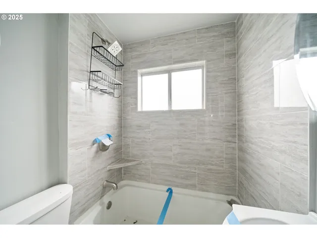 a bathroom with a bathtub and shower