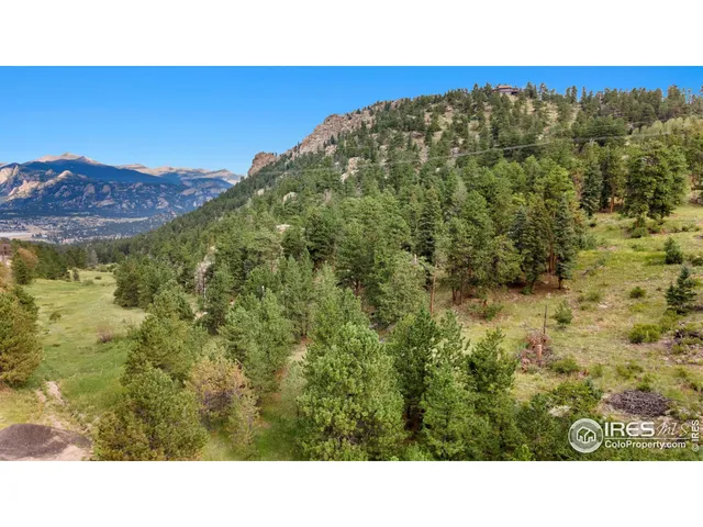 a open area with mountains in the background