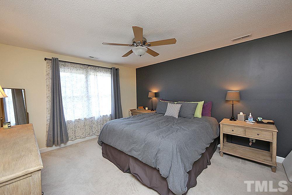 2204 Quail Ridge Road Raleigh, NC 27609 - Photo 12 of 25 a bedroom with a bed and a lamp with window