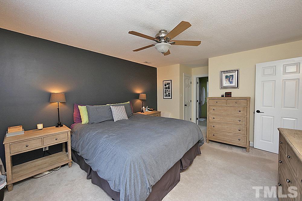 2204 Quail Ridge Road Raleigh, NC 27609 - Photo 13 of 25 a bedroom with a bed and a chandelier