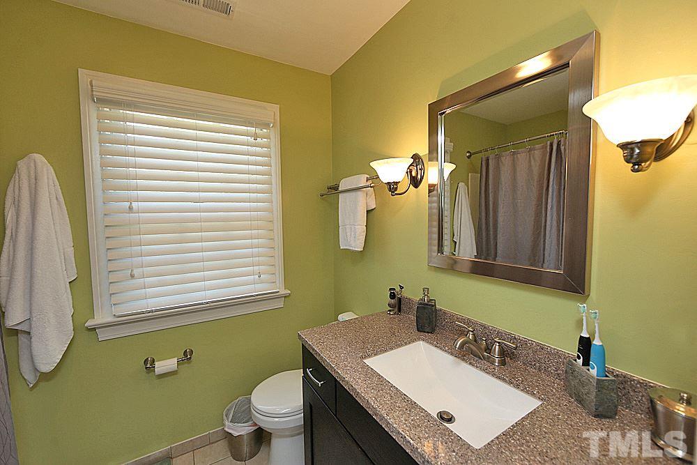 2204 Quail Ridge Road Raleigh, NC 27609 - Photo 14 of 25 a bathroom with a sink vanity mirror and toilet
