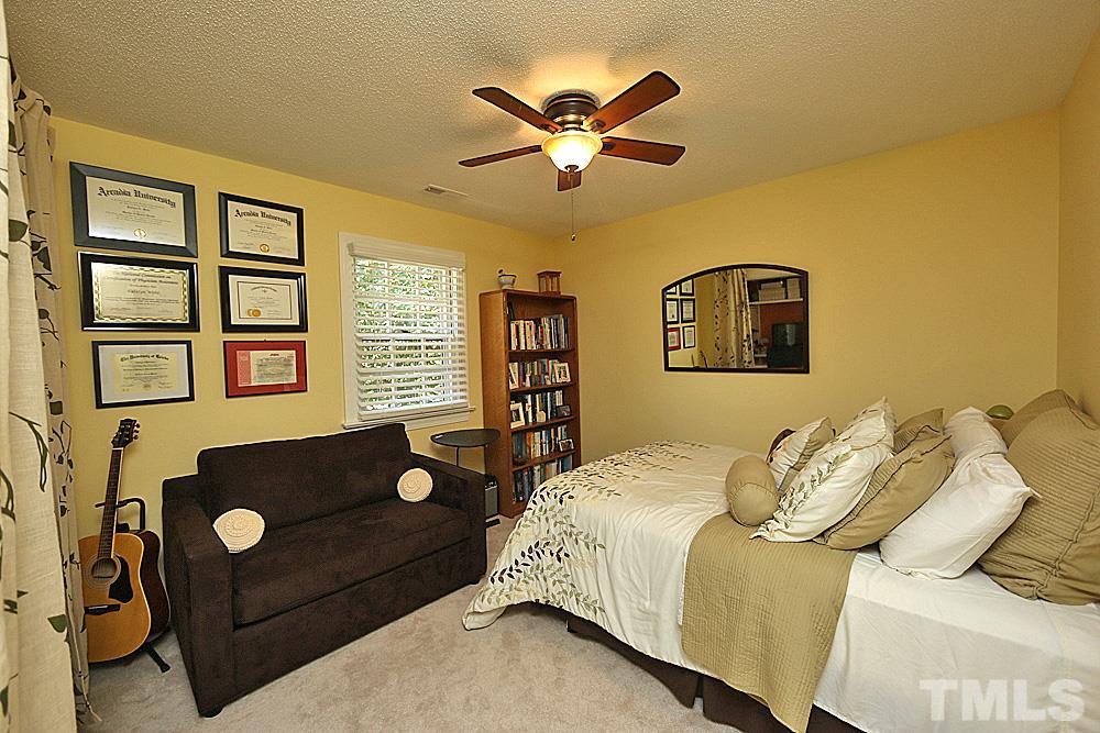 2204 Quail Ridge Road Raleigh, NC 27609 - Photo 17 of 25 a bedroom with a bed and wooden floor