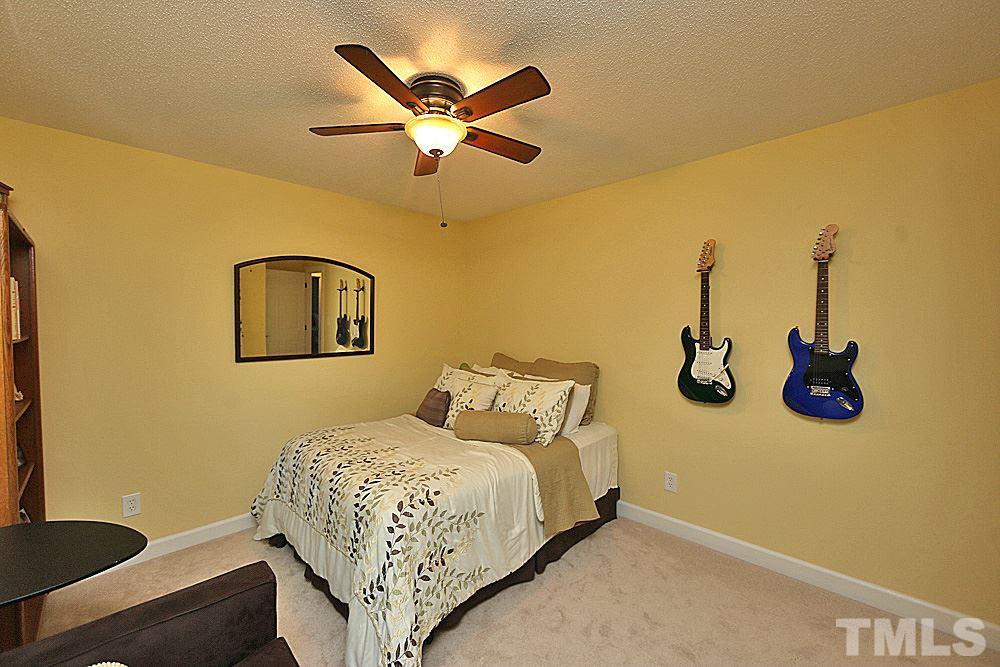 2204 Quail Ridge Road Raleigh, NC 27609 - Photo 18 of 25 a bedroom with a bed and a chandelier