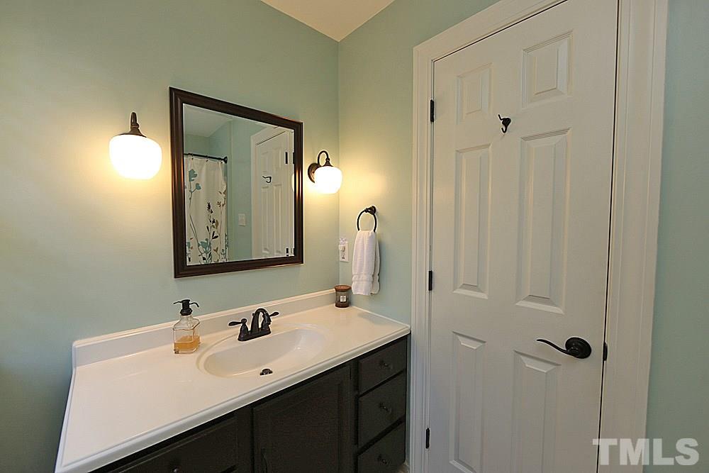 2204 Quail Ridge Road Raleigh, NC 27609 - Photo 19 of 25 a bathroom with a sink mirror and vanity
