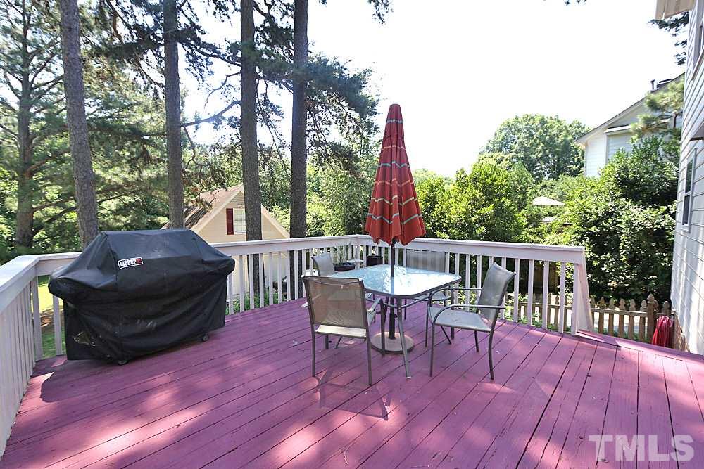 2204 Quail Ridge Road Raleigh, NC 27609 - Photo 20 of 25 a view of a patio with table and chairs and wooden floor