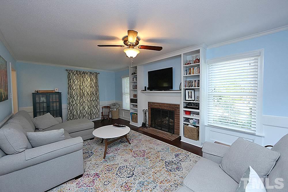 2204 Quail Ridge Road Raleigh, NC 27609 - Photo 5 of 25 a living room with furniture a flat screen tv and a fireplace