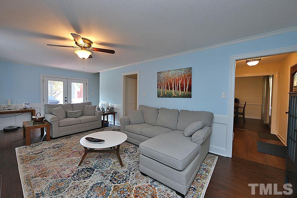 2204 Quail Ridge Road Raleigh, NC 27609 - Photo 6 of 25 a living room with furniture a rug and a chandelier
