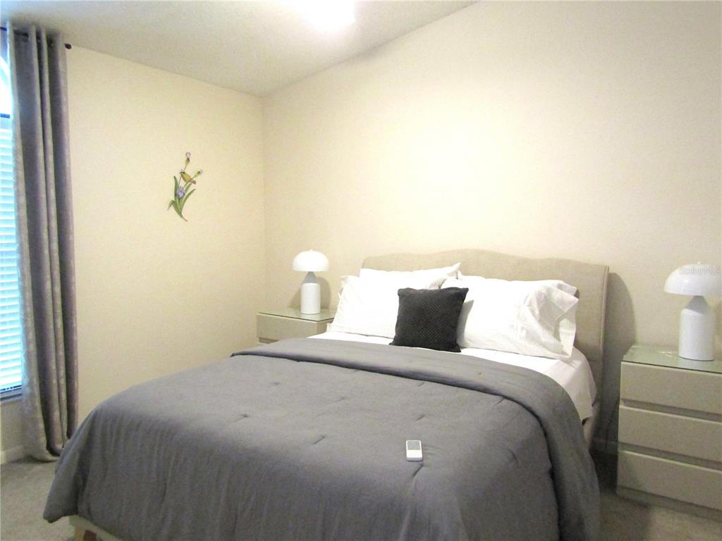 4521 Morningside, Unit 6 Sarasota, FL 34235 - Photo 15 of 22 a bedroom with bed and a night stand