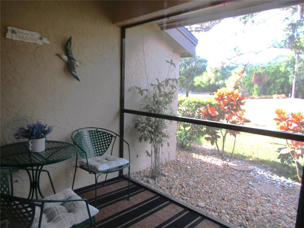4521 Morningside, Unit 6 Sarasota, FL 34235 - Photo 22 of 22 a view of a porch with furniture and a yard