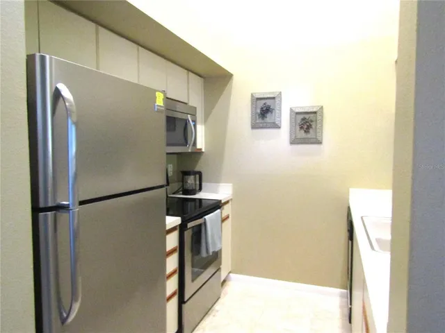a kitchen with a refrigerator and a stove