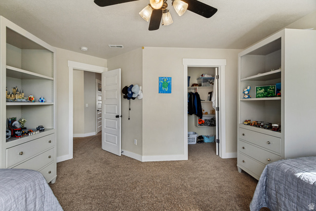 40 Wheeler Road Heber City, UT 84032 - Photo 18 of 41 Built-in storage shelving with drawers, recessed closet with shelving, ceiling fan light fixture, and neutral wall paint