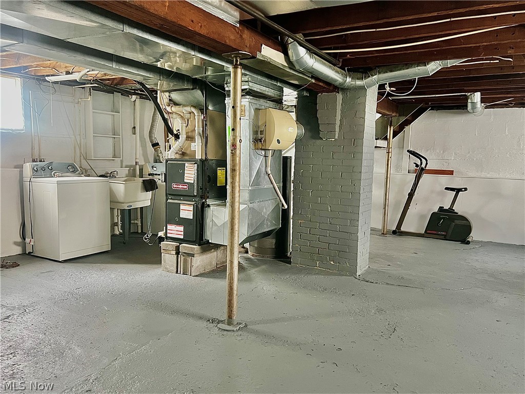 67 Forbes Road Bedford, OH 44146 - Photo 18 of 20 Basement with washer / clothes dryer and heating unit