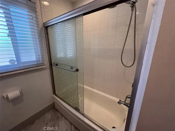 a bathroom with a glass shower door