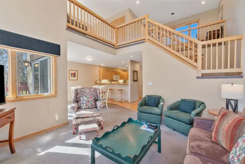 a dining room with furniture and a flat screen tv