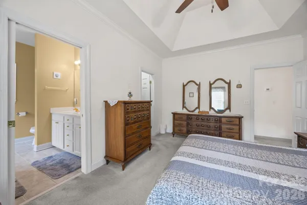 a bedroom with furniture and a mirror