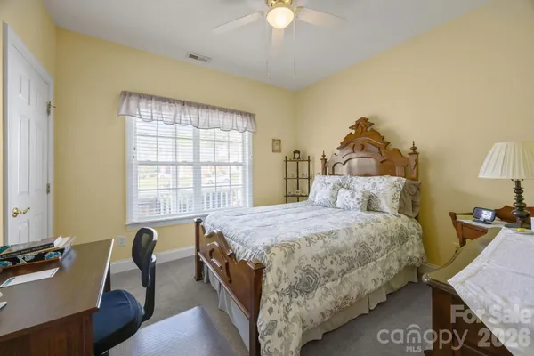 a bedroom with a bed and a table