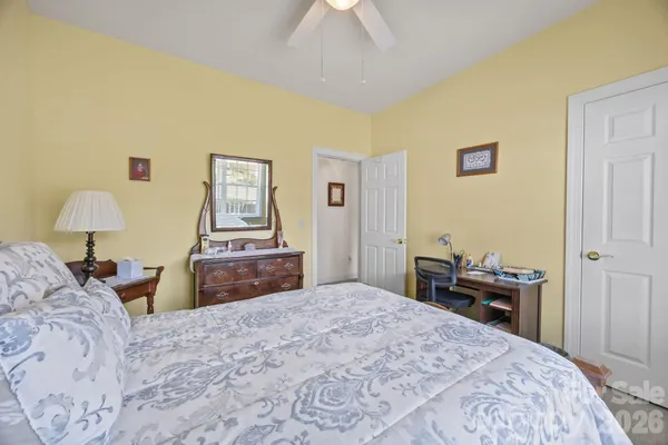 a bedroom with a bed and a lamp on table