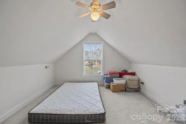 a living room with furniture and ceiling fan