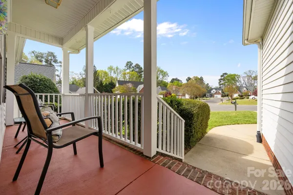 a view of a porch with furniture and garden