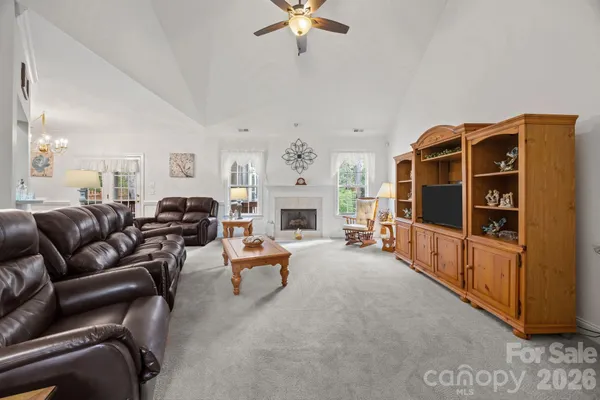 a living room with furniture and fireplace