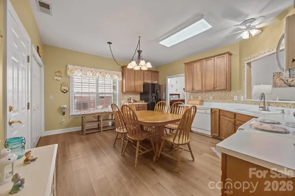 a view of a dining room with furniture and chandelier
