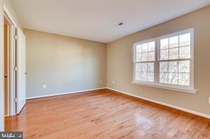45033 Fellowship Square Ashburn, VA 20147 - Photo 1 of 37 an empty room with wooden floor and windows
