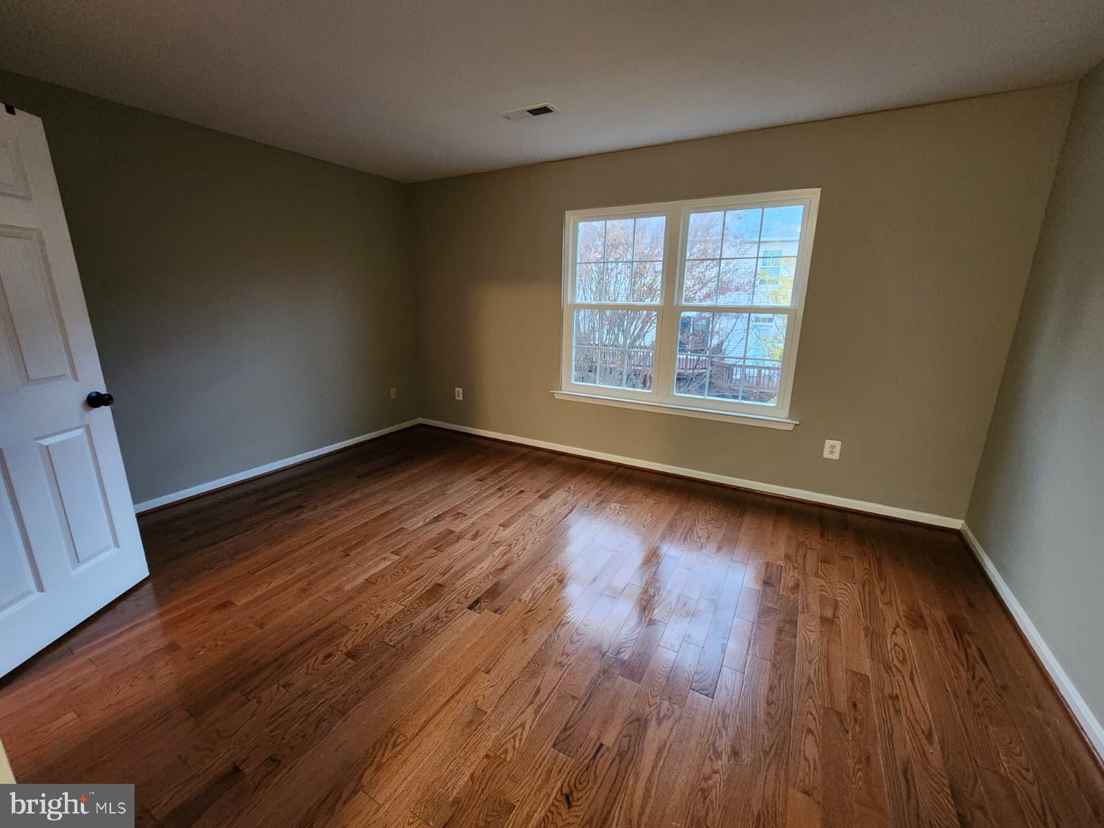 45033 Fellowship Square Ashburn, VA 20147 - Photo 18 of 37 an empty room with wooden floor and windows