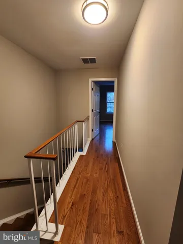 a view of hallway with wooden floor
