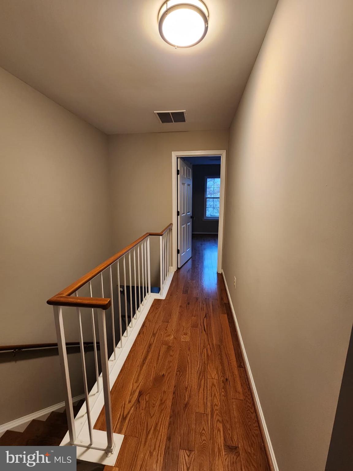 45033 Fellowship Square Ashburn, VA 20147 - Photo 19 of 37 a view of a hallway with wooden floor and staircase