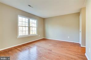 45033 Fellowship Square Ashburn, VA 20147 - Photo 2 of 37 a view of an empty room with wooden floor and a window