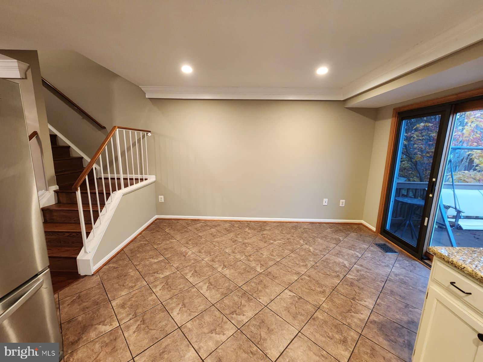 45033 Fellowship Square Ashburn, VA 20147 - Photo 28 of 37 a view of an empty room with stairs and a window