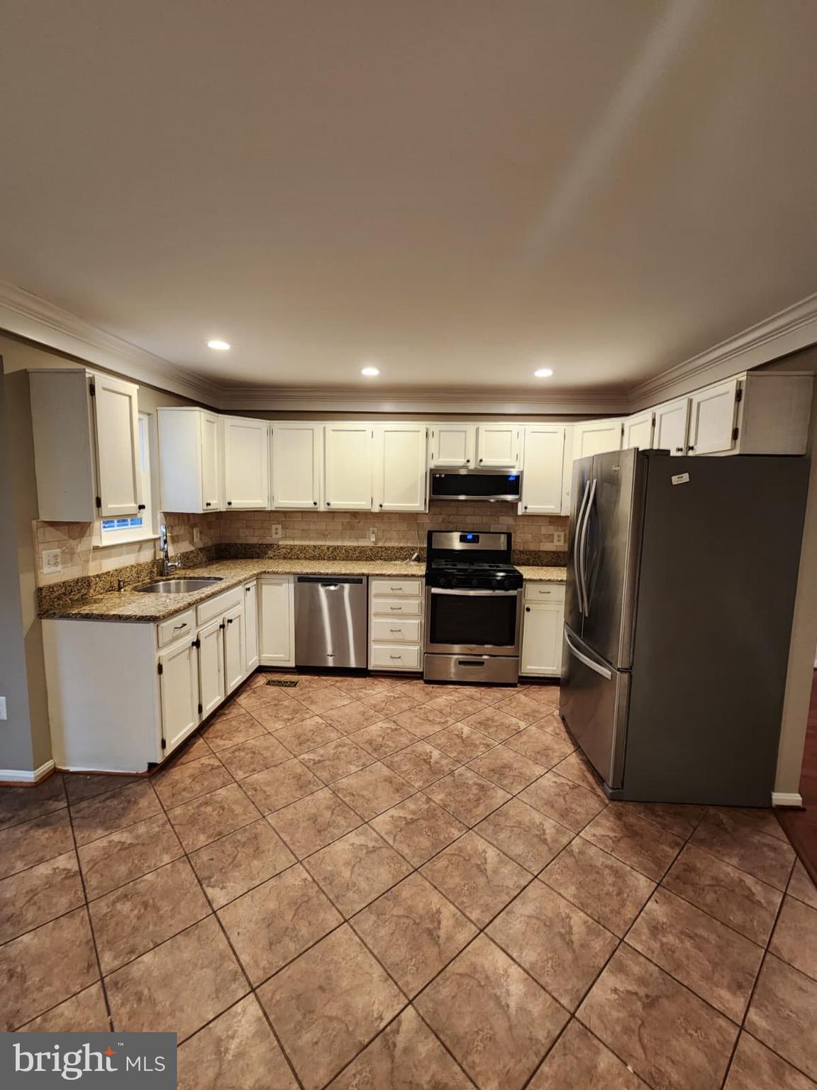 45033 Fellowship Square Ashburn, VA 20147 - Photo 29 of 37 a large kitchen with cabinets and stainless steel appliances