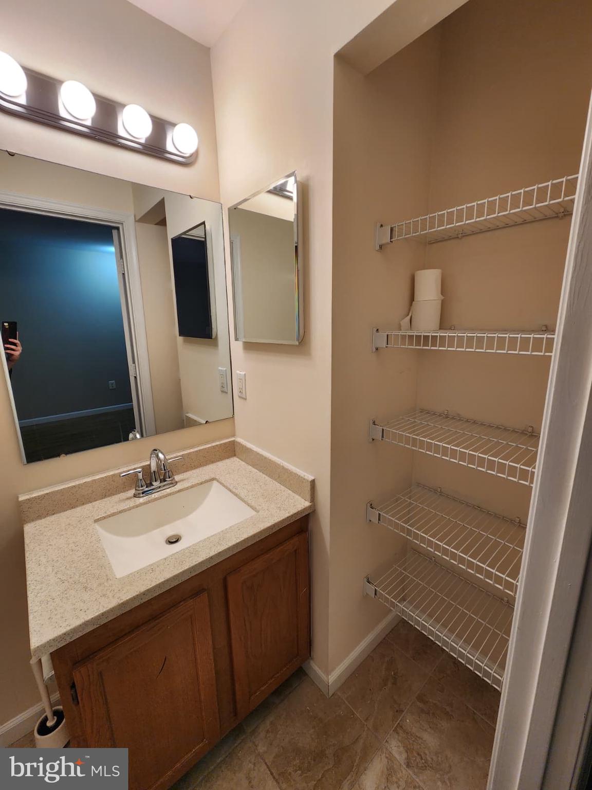 45033 Fellowship Square Ashburn, VA 20147 - Photo 31 of 37 a bathroom with a sink and a mirror