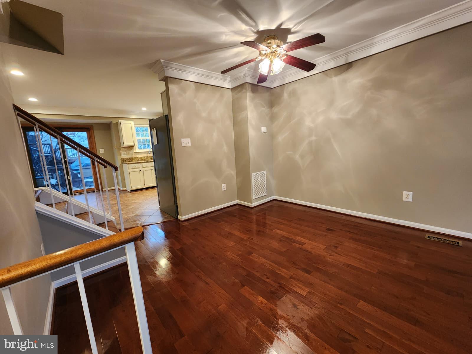 45033 Fellowship Square Ashburn, VA 20147 - Photo 33 of 37 a view of an empty room with wooden floor and a ceiling fan
