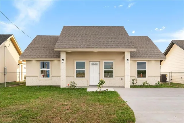 a front view of a house with a garden