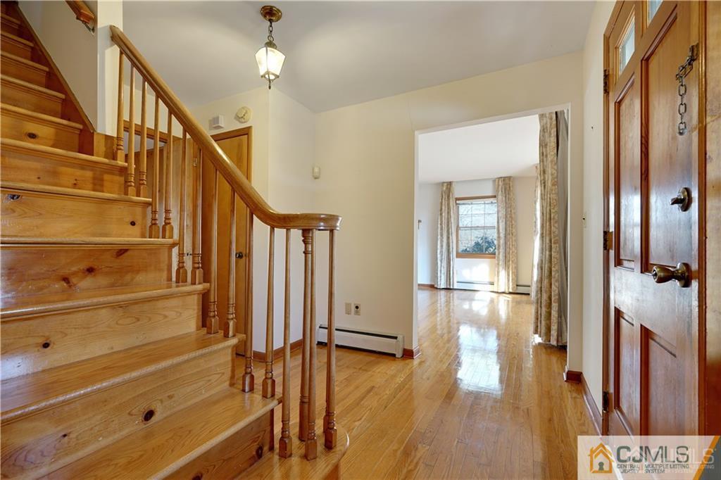 124 Sunset Road Belle Mead, NJ 08502 - Photo 3 of 29 a view of an entryway with wooden floor and door