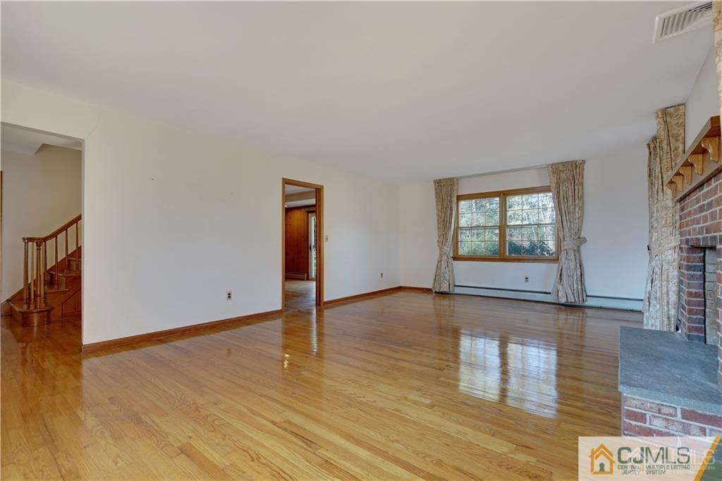 124 Sunset Road Belle Mead, NJ 08502 - Photo 4 of 29 an empty room with wooden floor and windows
