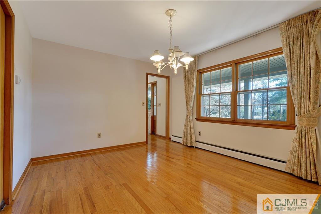 124 Sunset Road Belle Mead, NJ 08502 - Photo 8 of 29 a view of an empty room with window and wooden floor
