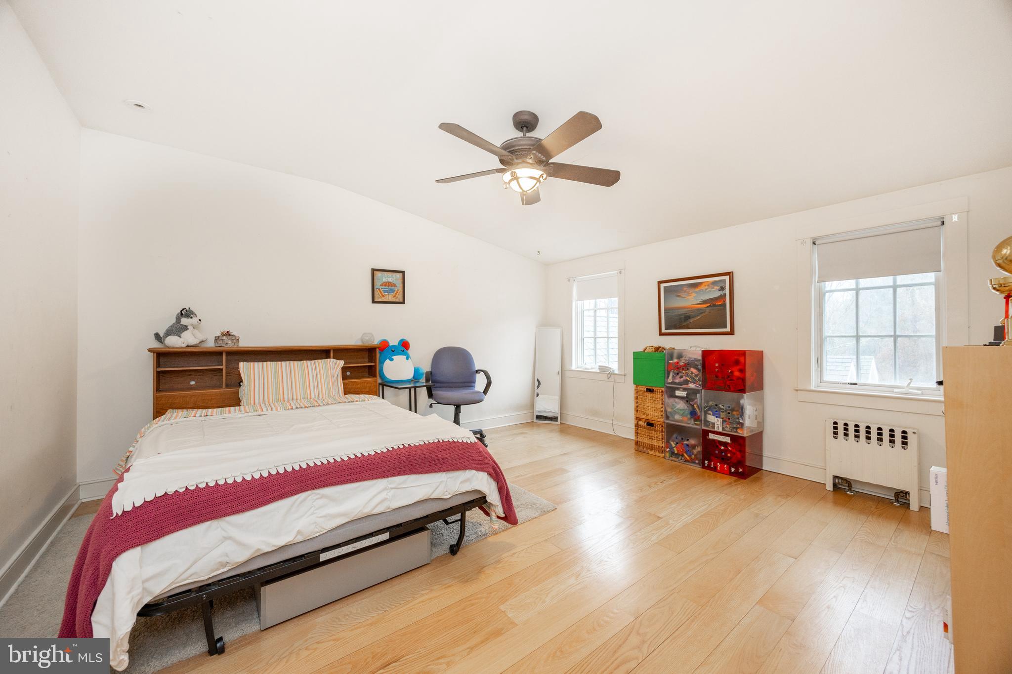 580 Reeds Road Downingtown, PA 19335 - Photo 29 of 82 a bedroom with a bed a couch and a chandelier