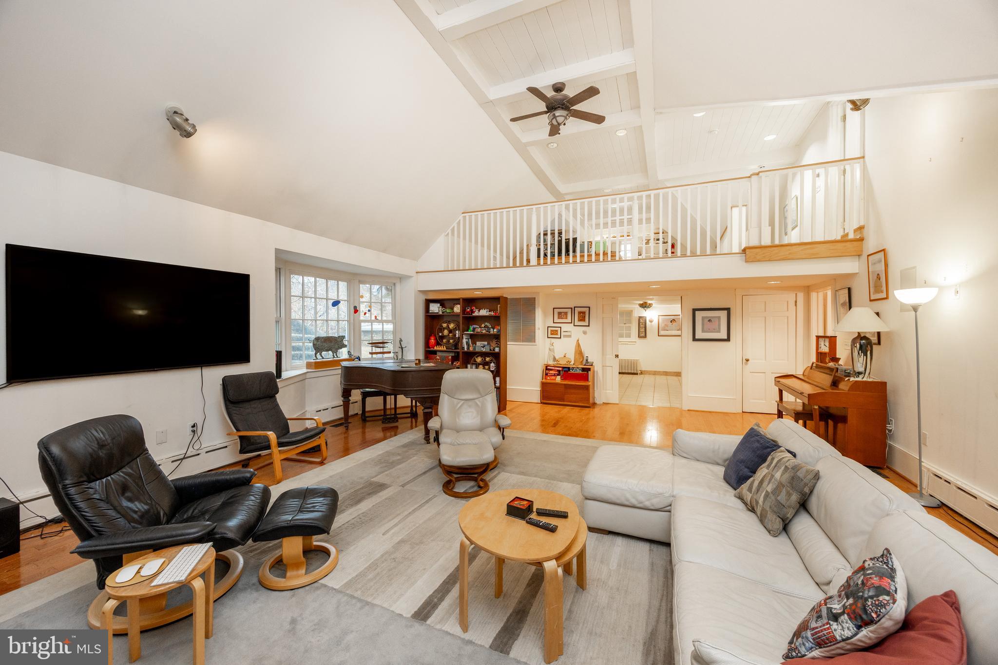 580 Reeds Road Downingtown, PA 19335 - Photo 37 of 82 a living room with furniture a flat screen tv and a floor to ceiling window